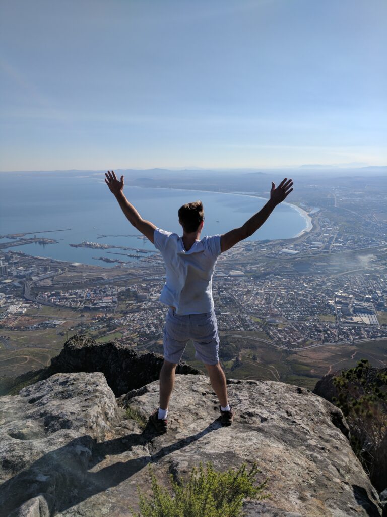 Man looking down at Cape Town Triumphant after climbing the India Venster trail up Table Mountain