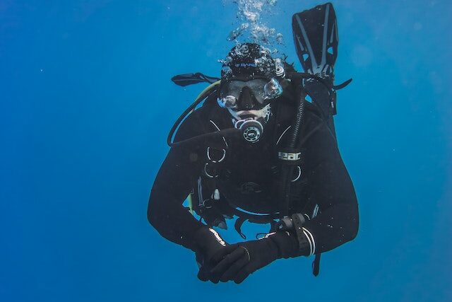 Scuba Diver looking into the camera underwater
