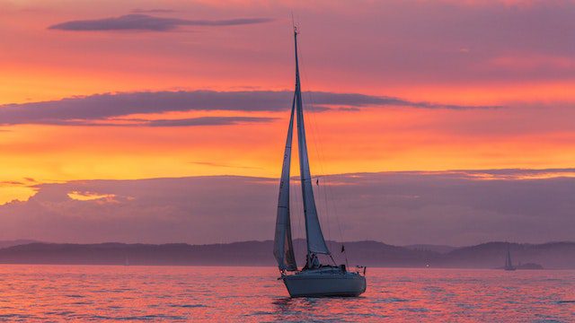 A yacht sailing at sunset